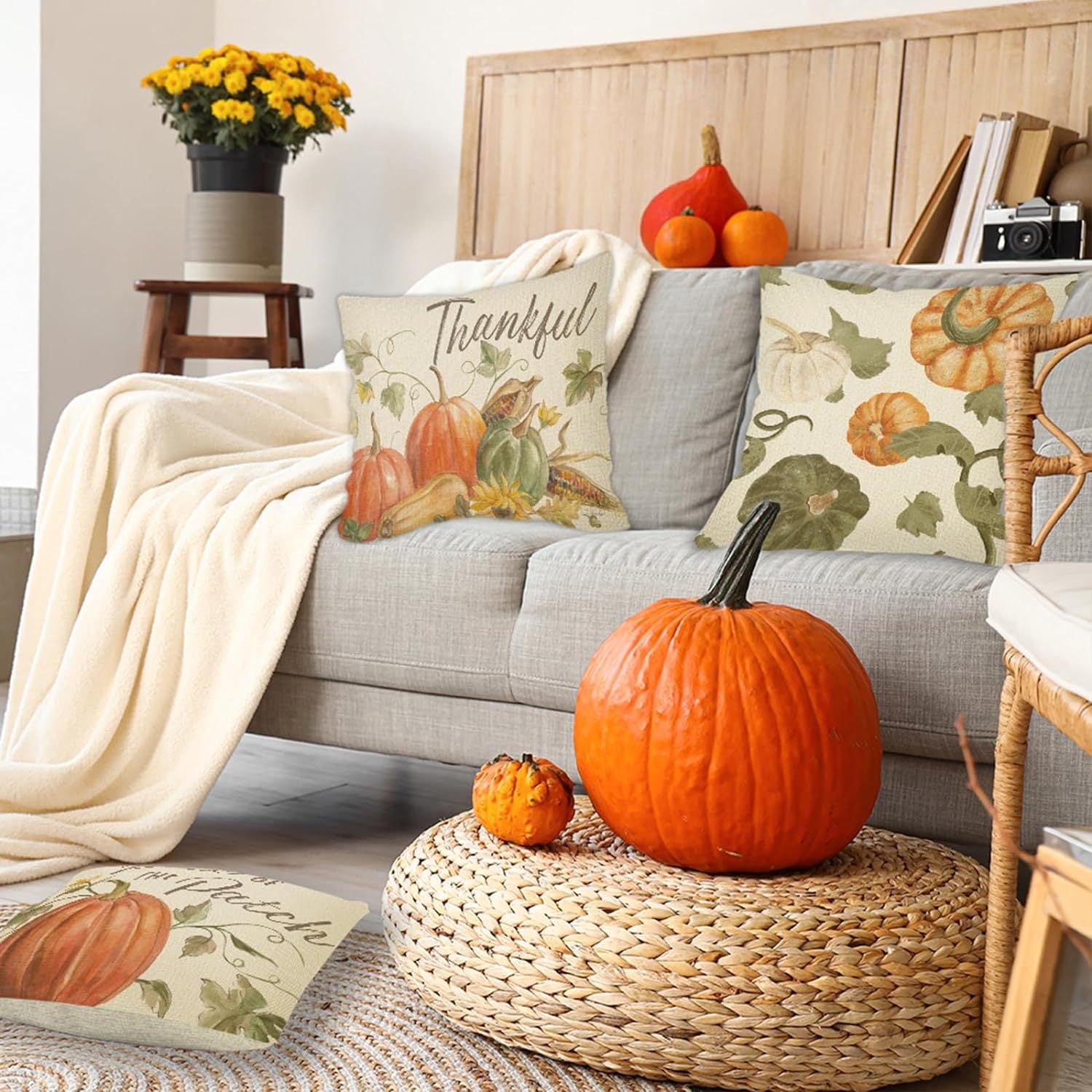 Cozy living room featuring 4PCS Thanksgiving Pillow Covers on a sofa with a pumpkin centerpiece.